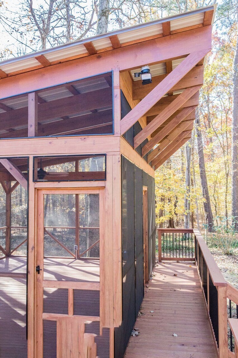 Angled roof wooden screened porch with deck, completed by Craft Design + Build in Essex, Connecticut