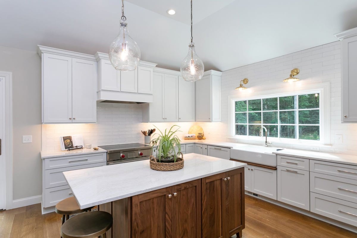 Breakfast nook with a wooden dining table and white chairs, connected to a remodeled kitchen in Essex, Connecticut