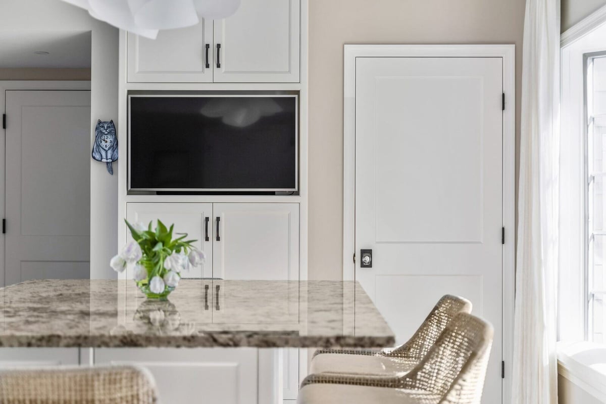 Bright kitchen nook with granite countertop and built-in cabinetry by [Your Company Name], Essex, Connecticut