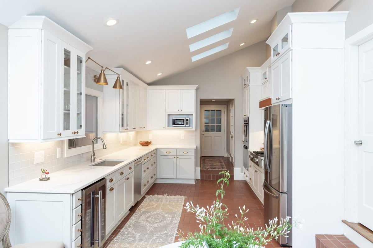 Bright kitchen renovation featuring white cabinets and a long countertop in Essex, Connecticut