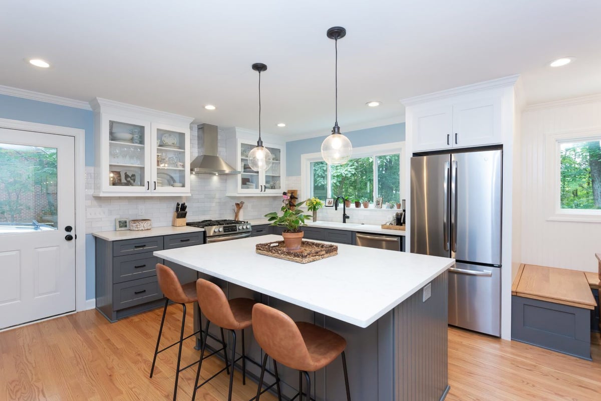 Bright kitchen with large island and pendant lighting in Essex, Connecticut, by Craft Design + Build