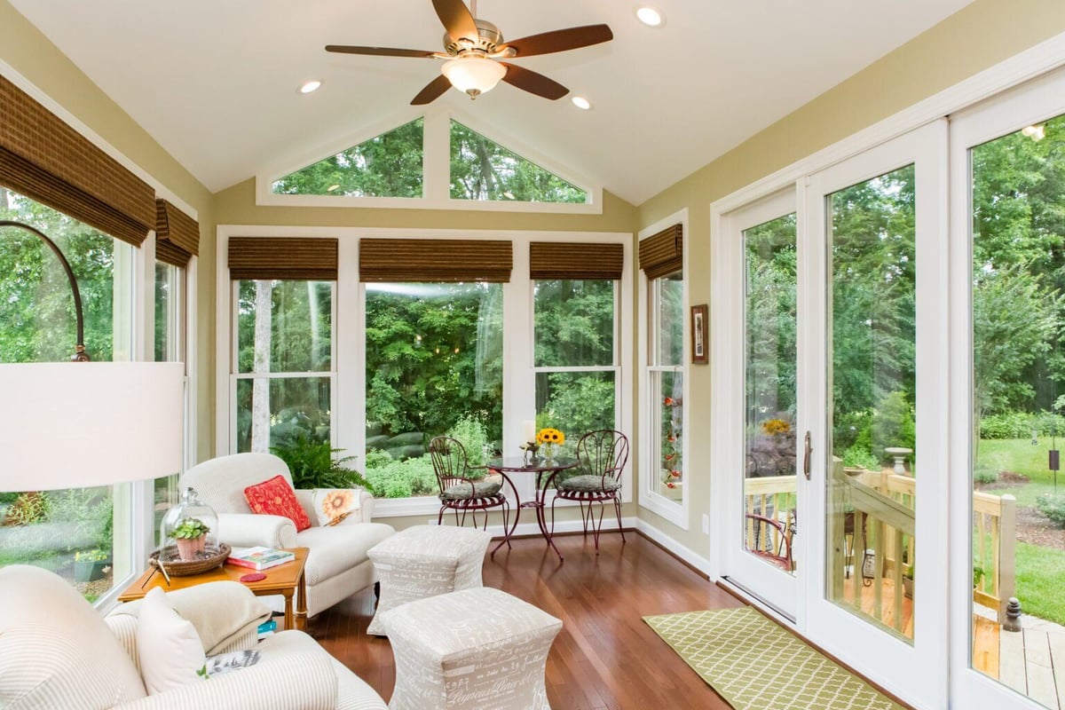 Bright sunroom interior with a modern ceiling fan and outdoor access in Essex, Connecticut