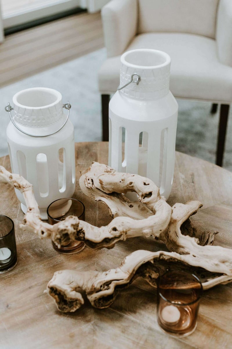 Close-up of decorative white lanterns and driftwood centerpiece in a 4 seasons room in Essex, Connecticut