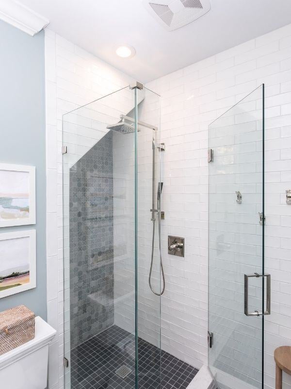 Contemporary bathroom with glass shower in a South Raleigh renovation by Craft Design + Build