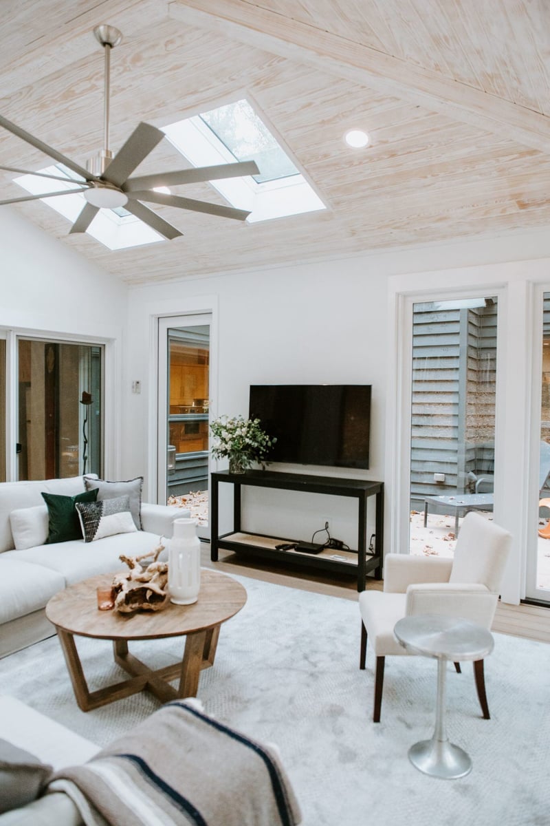 Cozy sitting area with natural light in a 4 seasons room addition in Essex, Connecticut, by Craft Design + Build