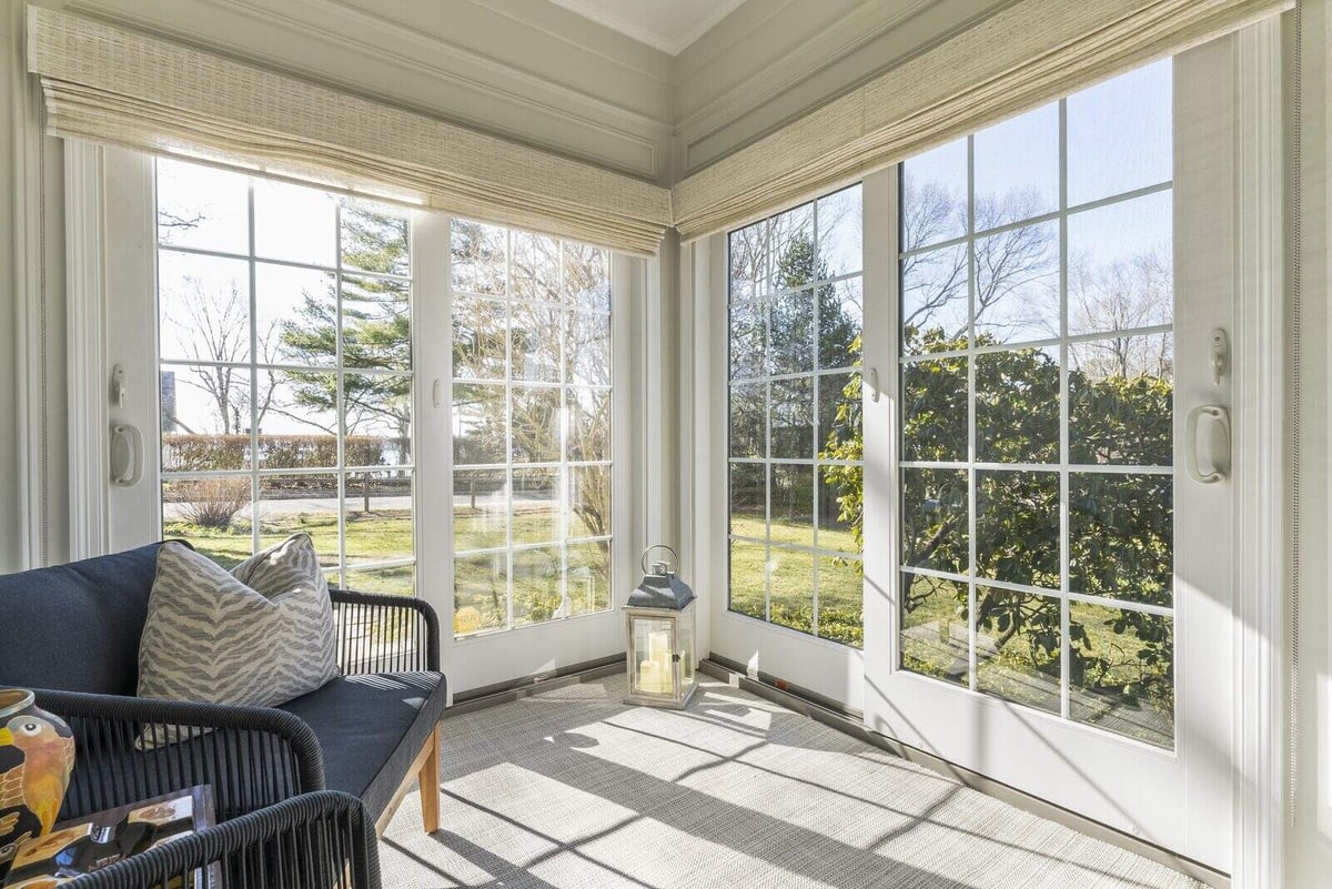 Cozy sunroom with large windows in Essex home remodel by Craft Design + Build, Essex Connecticut