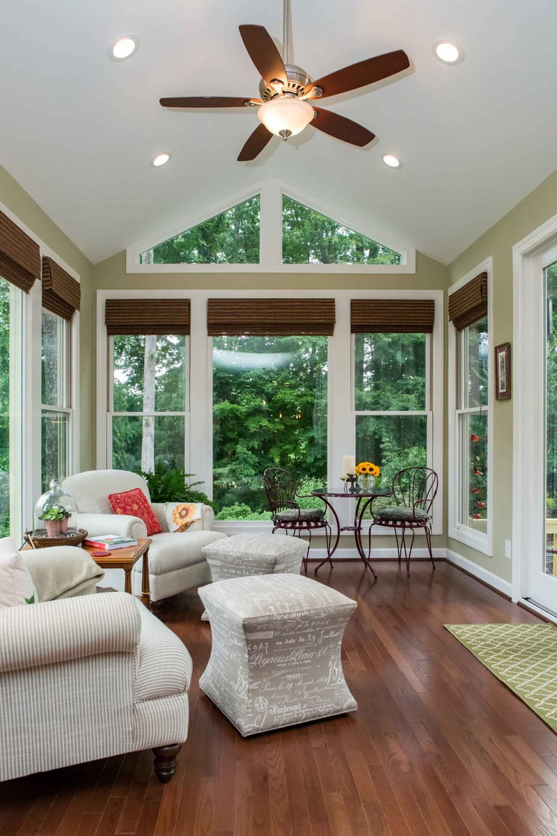 Custom sunroom addition with cozy seating area in Essex, Connecticut by Craft Design + Build