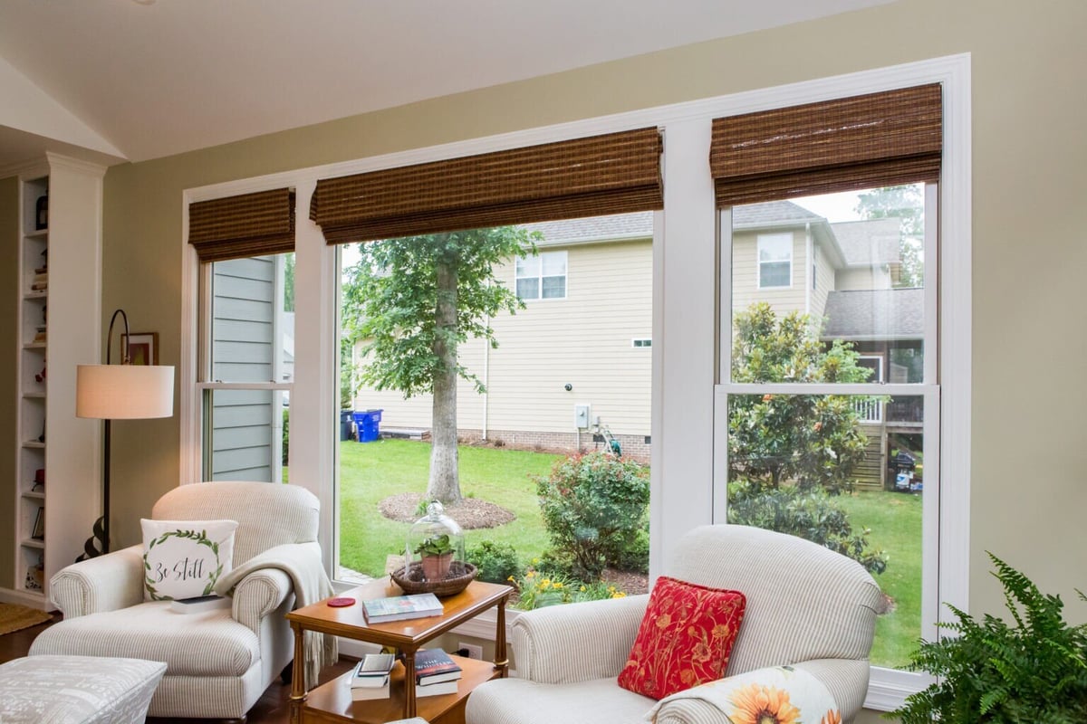 Custom sunroom addition with large windows overlooking a backyard in Essex, Connecticut