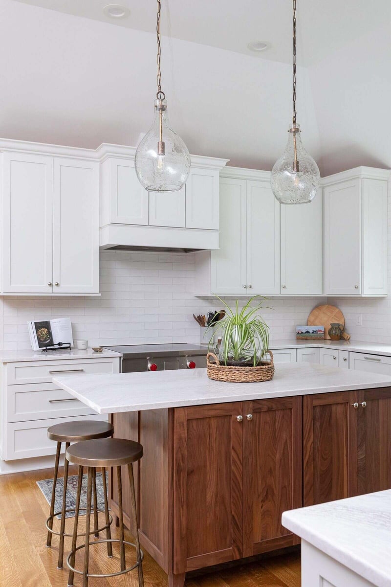 Detail of a kitchen featuring a wooden island and white cabinets in an Essex, Connecticut remodel