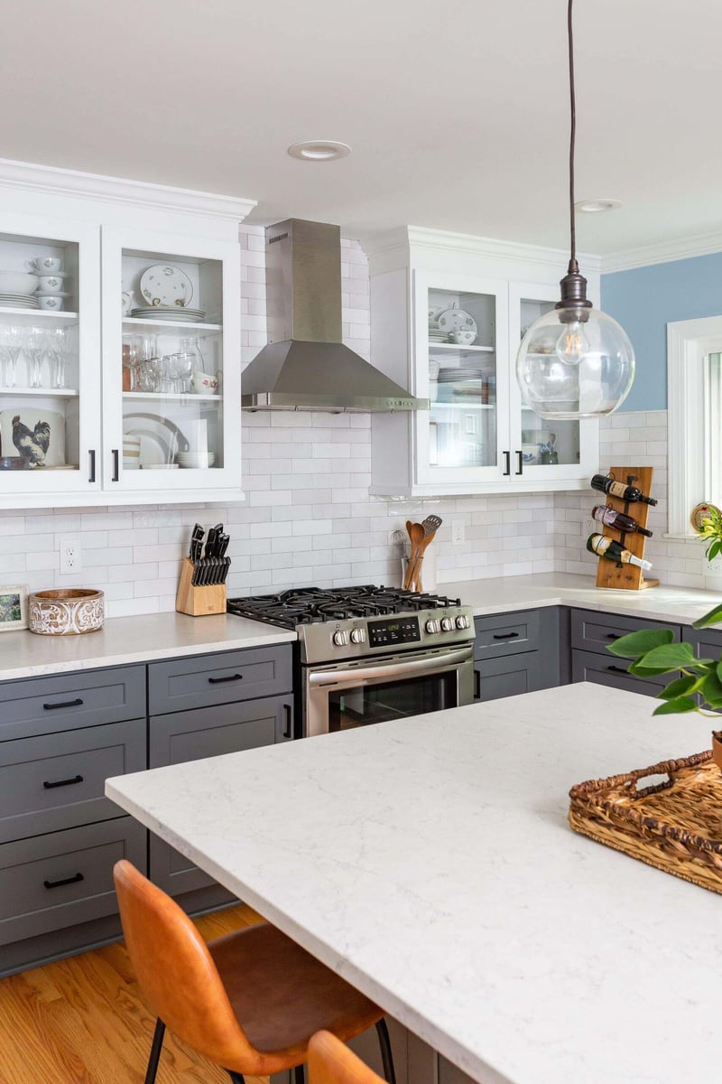 Elegant kitchen with stainless steel range and gray cabinetry in an Essex home remodel by Craft Design + Build