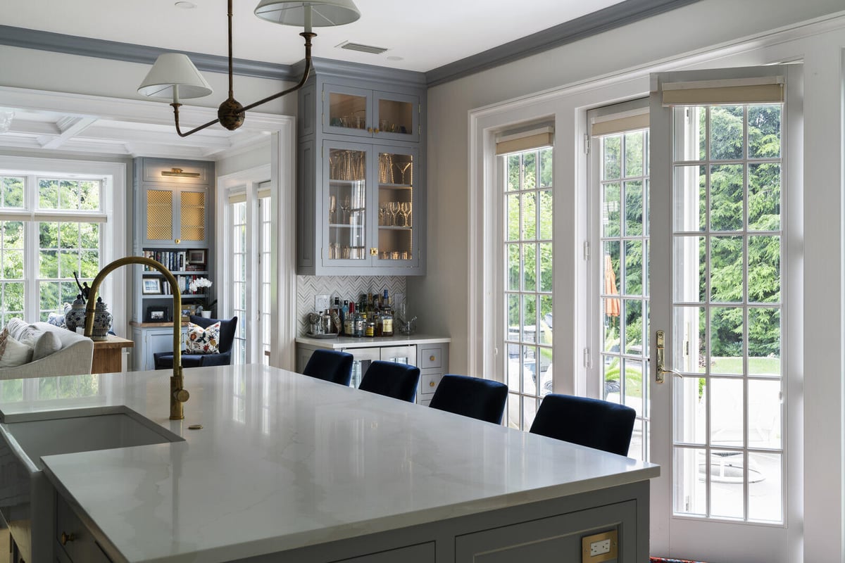 Bright kitchen with French doors leading outside, remodeled by Craft Design and Build in Essex, Connecticut