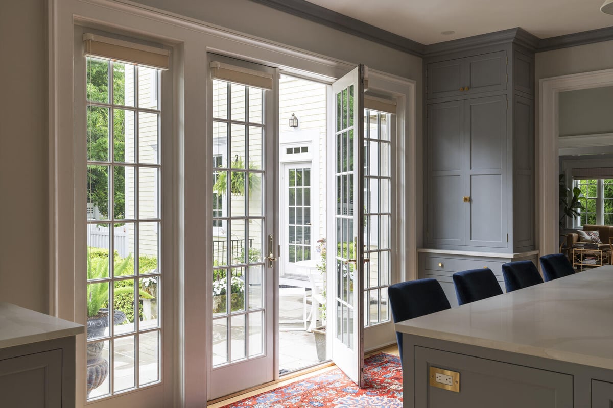 Kitchen with tall grey cabinets and a Persian rug, remodeled by Craft Design and Build in Essex, Connecticut