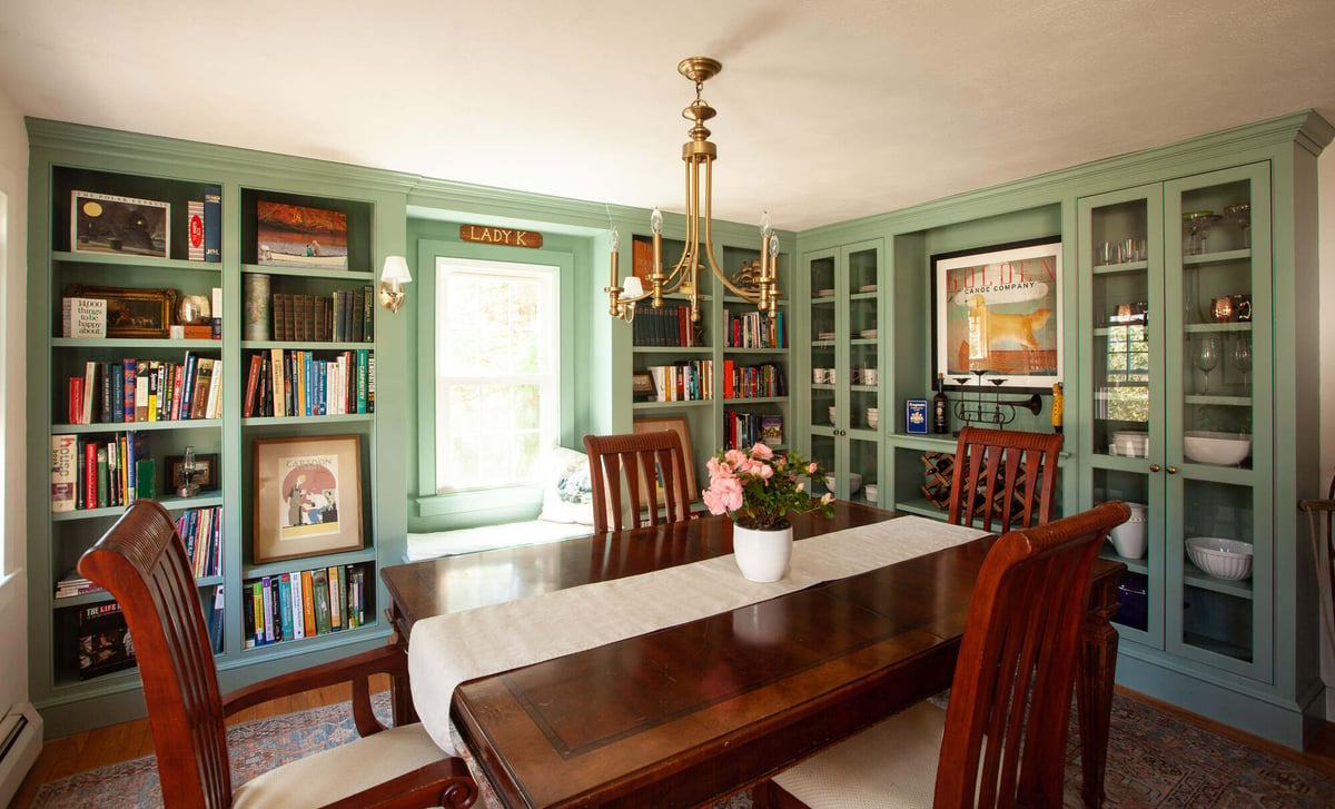 Dining room with built-in shelves and chandelier by Craft Design and Build, Essex, Connecticut