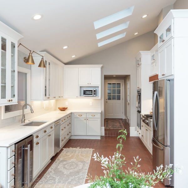 Kitchens, Essex, Connecticut kitchen renovation by CRAFT design+build, with vaulted ceilings and sleek white cabinetry