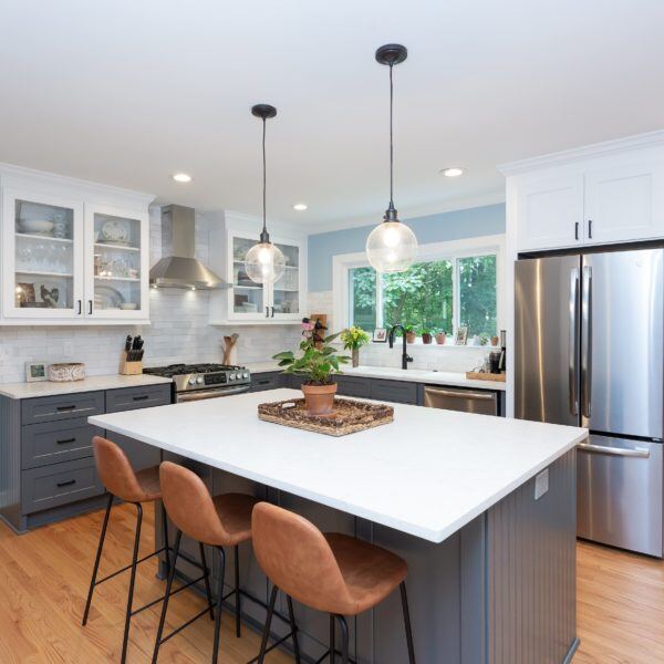 Kitchens, Essex, Connecticut remodel by CRAFT design+build, showcasing an open layout with a central island and pendant lighting