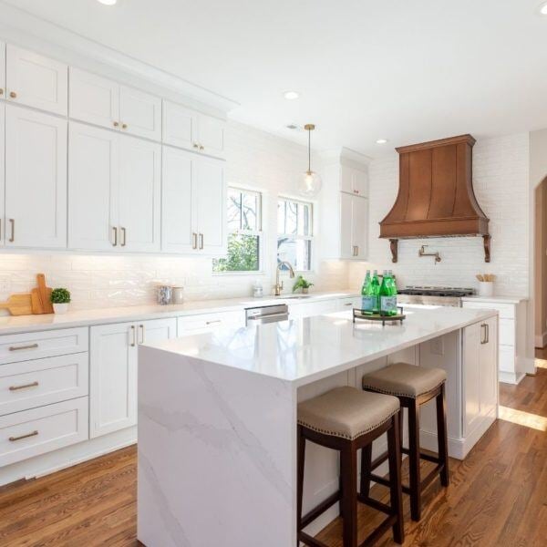 Luxurious Essex, Connecticut kitchen remodel with marble countertops and white cabinets by Craft Design + Build