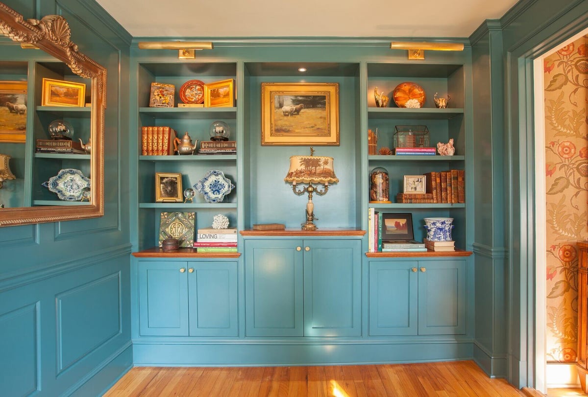 Luxurious home library with teal built-in bookshelves, designed by Craft Design + Build, Essex, Connecticut