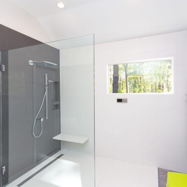 Minimalist shower area with glass enclosure in an Essex, Connecticut bathroom renovation