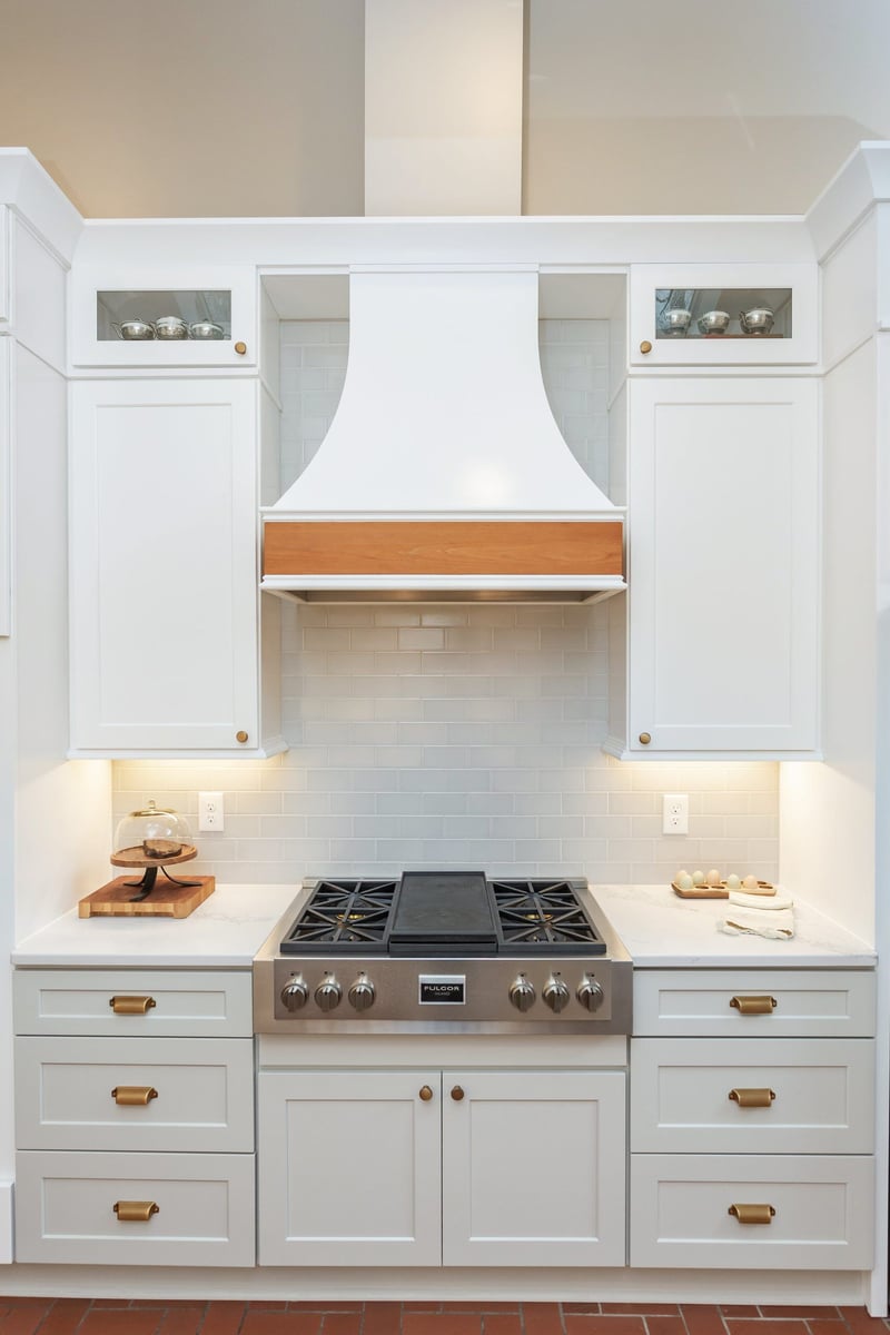 Modern kitchen with white cabinets, stainless steel appliances, and a central island in Essex, Connecticut