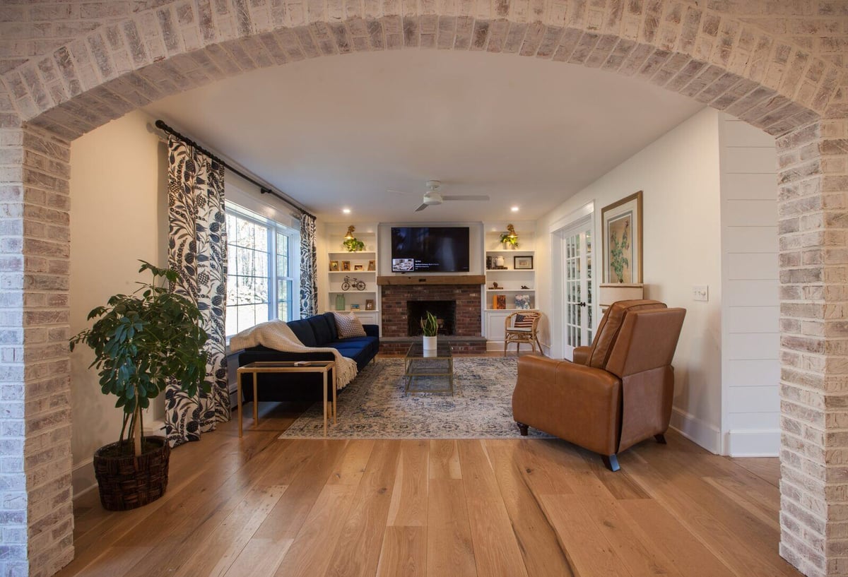 Narrow corridor with shiplap walls, ornate tile floor, and glass door, designed by Craft Design + Build in Essex, Connecticut