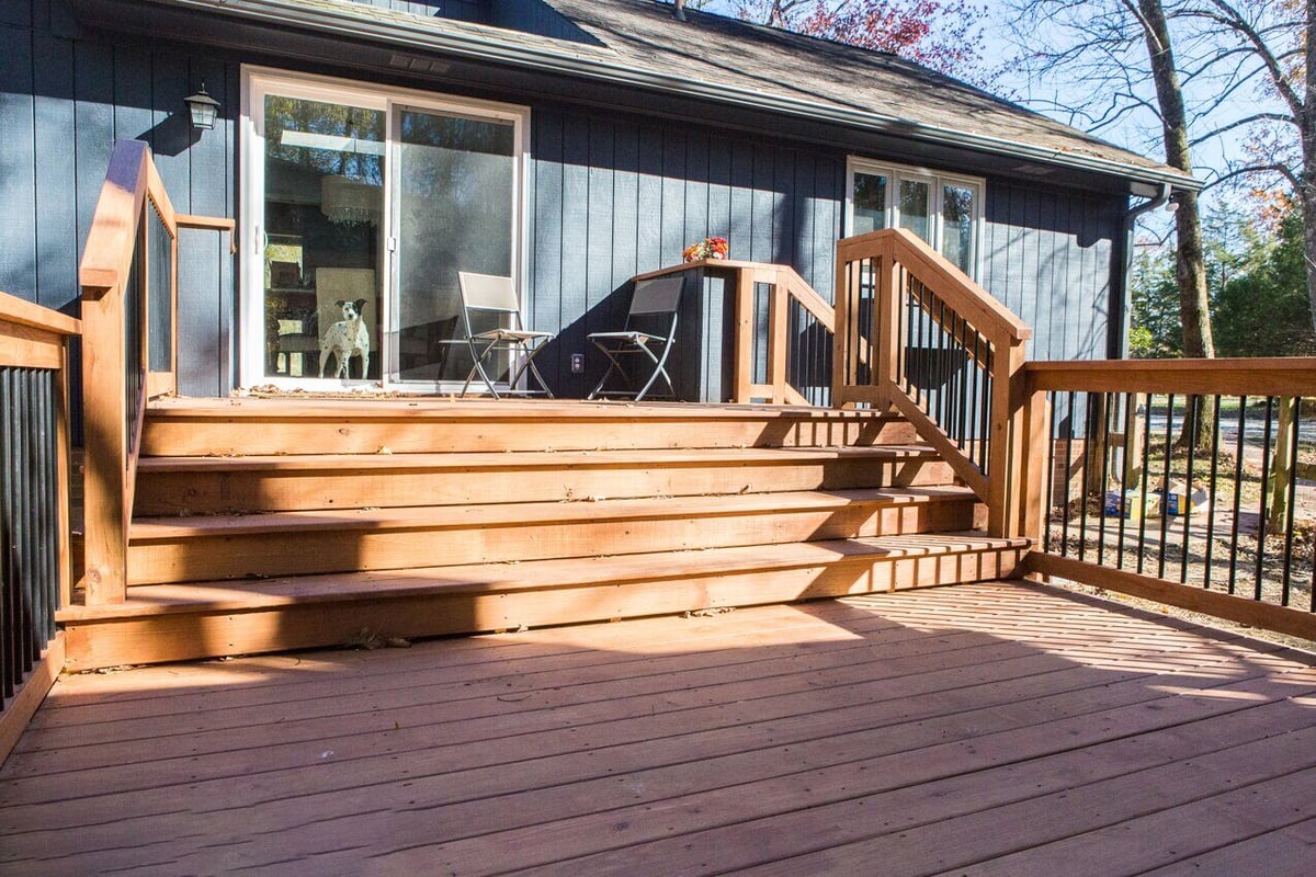 Outdoor wooden deck with stairway leading to a home’s entrance in Essex, completed by Craft Design + Build, Essex Connecticut