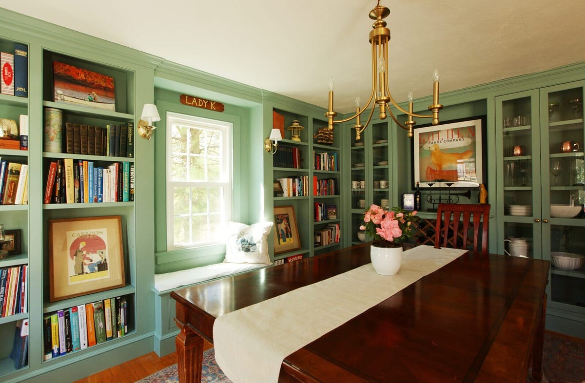 Remodeled dining room in Essex, Connecticut with custom green built-ins by Craft Design + Build