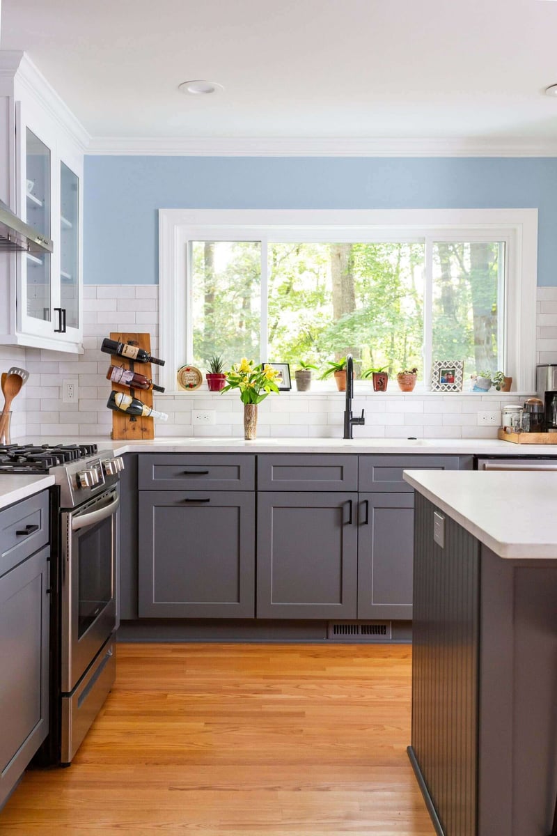 Remodeled kitchen featuring a window with a view and gray cabinets in Essex by Craft Design + Build