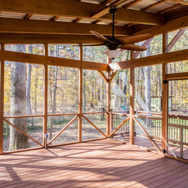 Rustic screened porch with wooden framework and outdoor views, remodeled by Craft Design + Build, Essex, Connecticut