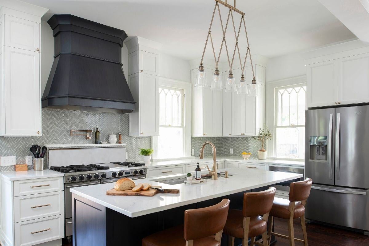 Sleek kitchen design featuring white cabinets, black accents, and a central island in an Essex, Connecticut historical home renovation b