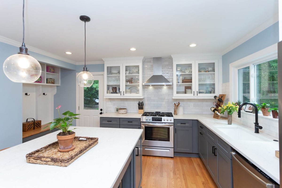 Spacious remodeled kitchen with gray and white cabinetry in Essex, Connecticut, by Craft Design + Build