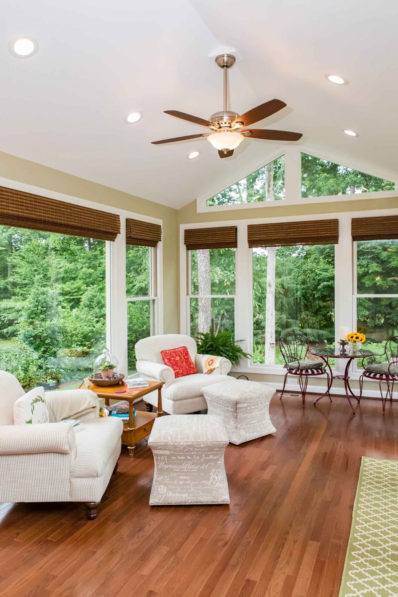 Sunroom addition featuring cozy seating and natural light in Essex, Connecticut by Craft Design + Build