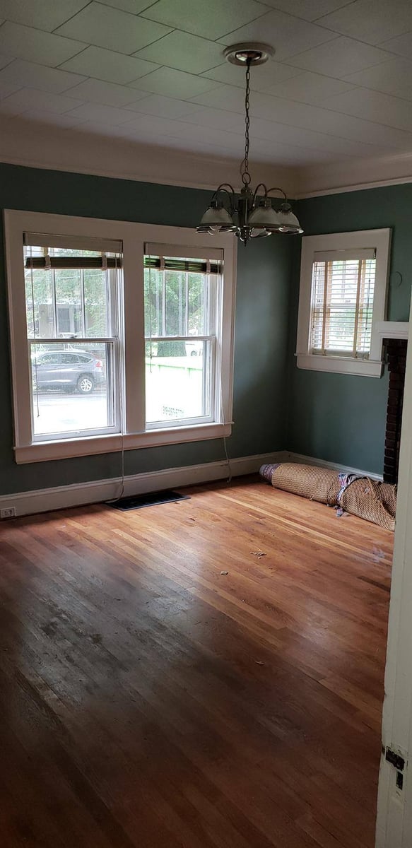 Unfurnished dining area with large windows and hardwood flooring, part of a whole-home renovation by Craft Design + Build in Essex, Con