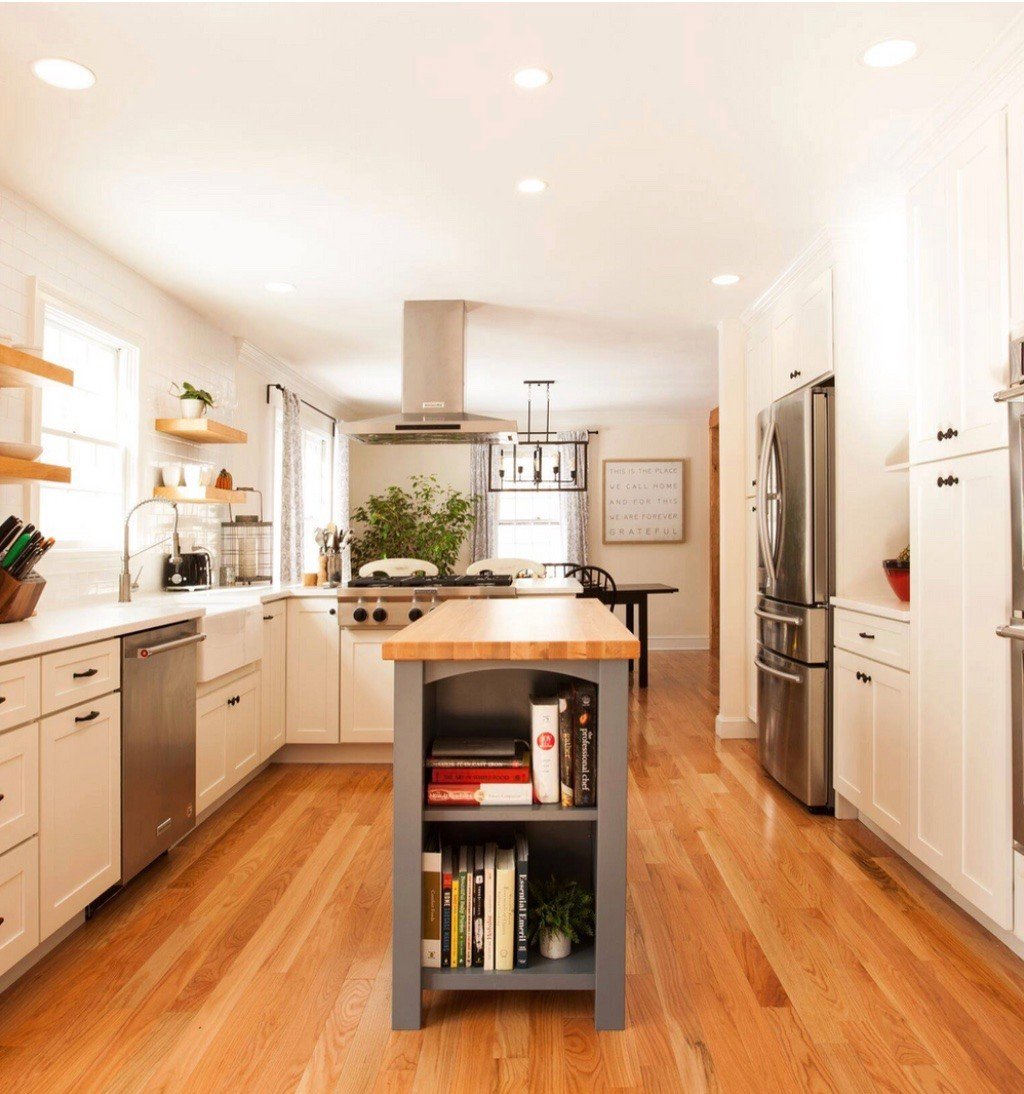 Updated kitchen with white cabinetry and open shelving, designed by Craft Design + Build in Killingworth, Essex, Connecticut