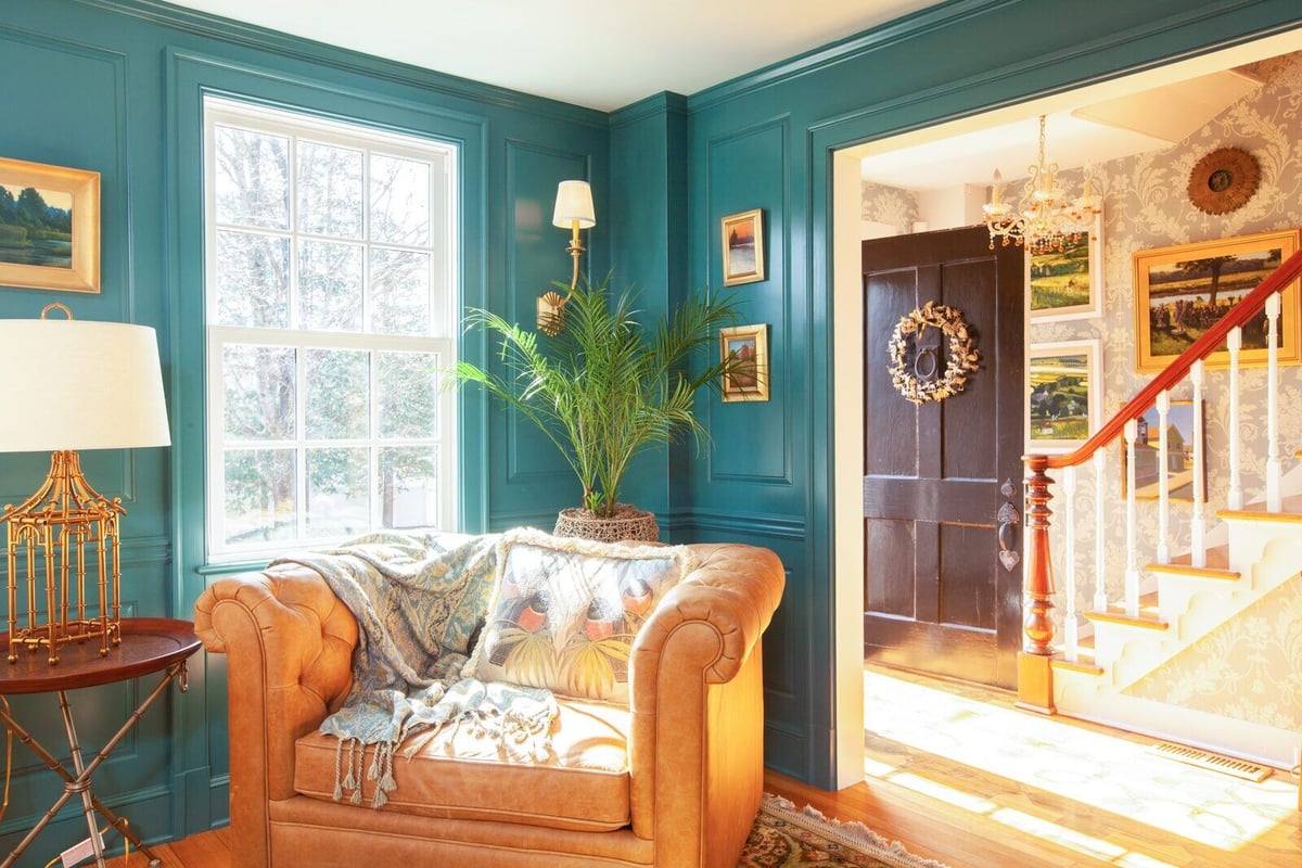 Welcoming entryway with a view of a sunlit sitting area in a Chester, Connecticut remodel by Craft Design + Build