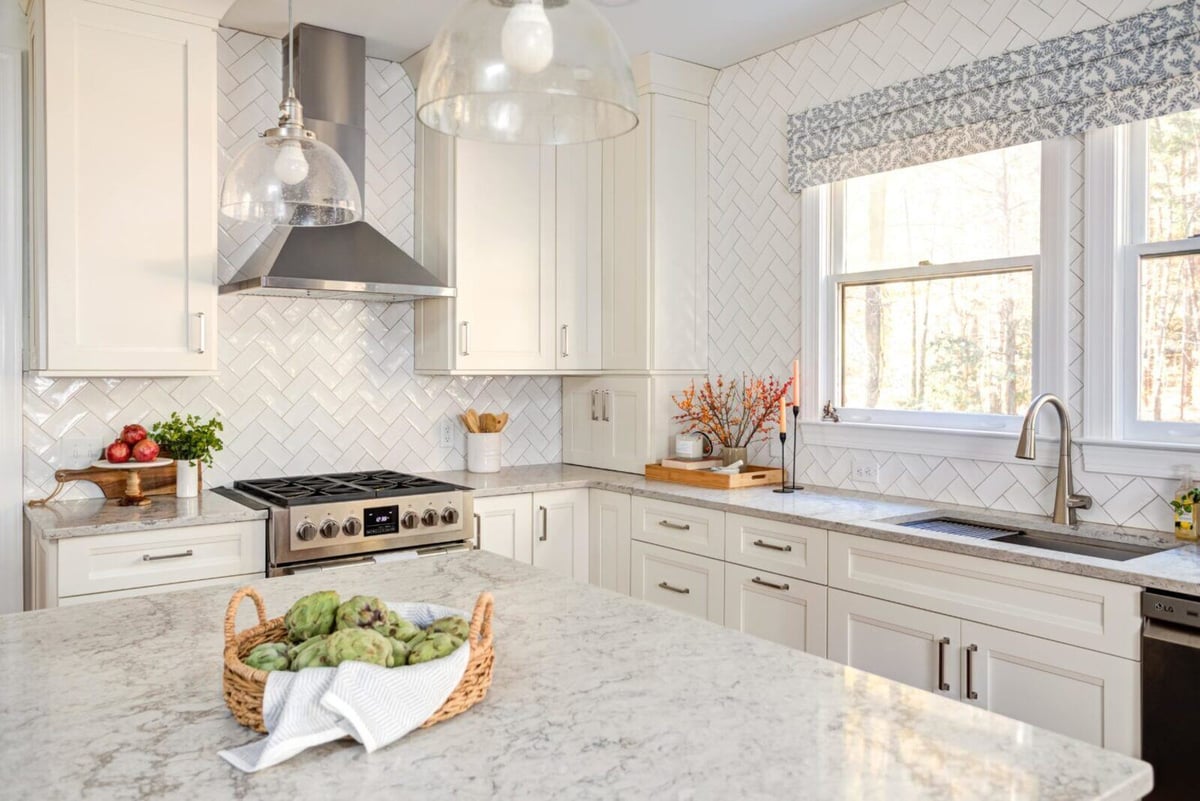 White and gray kitchen renovation with island centerpiece in Essex, Connecticut by Craft Design + Build