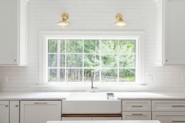 Wood island with marble countertop in a South Raleigh kitchen renovation by Craft Design + Build